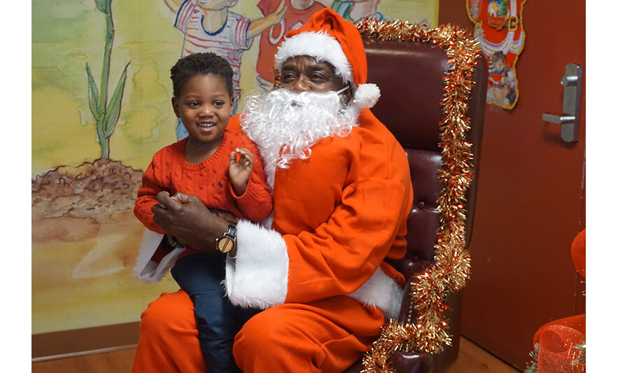 CHELC Santa Visit 12-16-2022 Boy in red sweater smiling for web