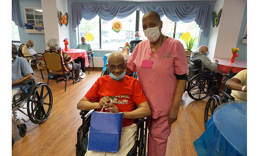 Extended Care Adopt-a-Resident Day 5-15-2024 Staff member in pink with woman in red for web