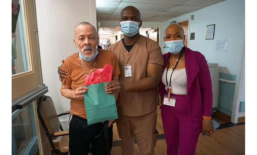 Extended Care Adopt-a-Resident Day 5-15-2025 Man with bag in hallway for web