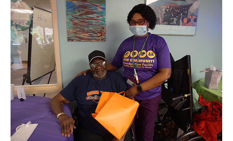 Extended Care Adopt-a-Resident Day 5-15-2025 Smiling man with orange bag for web