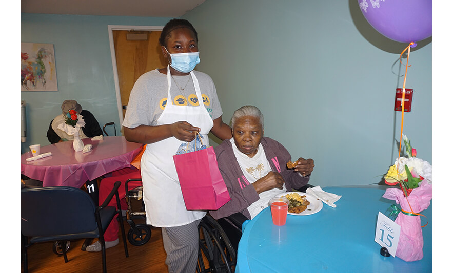 Extended Care Adopt-a-Resident Day 5-15-2025 Woman with food for web
