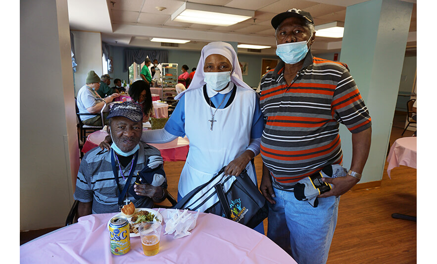 Extended Care Adopt-A-Resident Day 5-17-2023 Sister Elizabeth Lima with two men for web