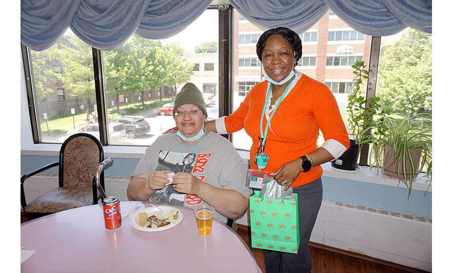 Extended Care Adopt-A-Resident Day 5-17-2023 Yonette Semple with man by window for web